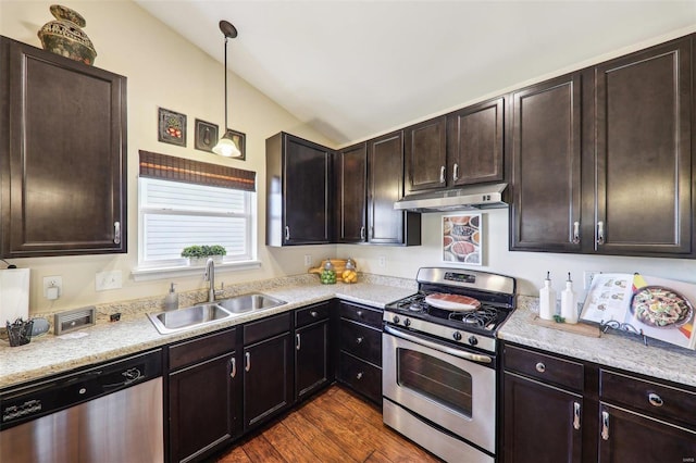 kitchen with lofted ceiling, appliances with stainless steel finishes, dark wood-style flooring, under cabinet range hood, and a sink