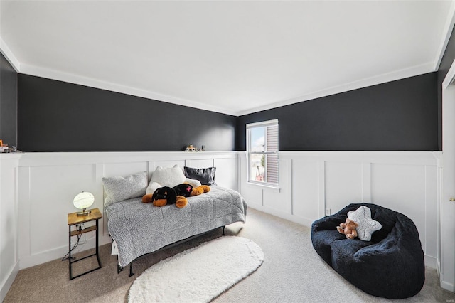 bedroom with carpet and wainscoting