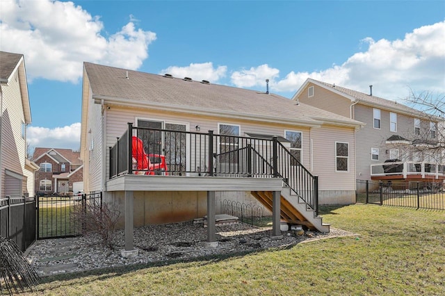 rear view of house with a wooden deck, stairs, fence, and a yard