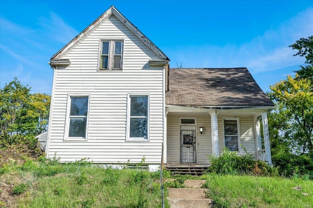 traditional-style home with a shingled roof