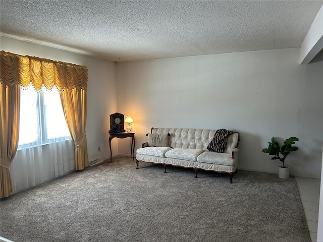 tiled living room with carpet floors, visible vents, and a textured ceiling