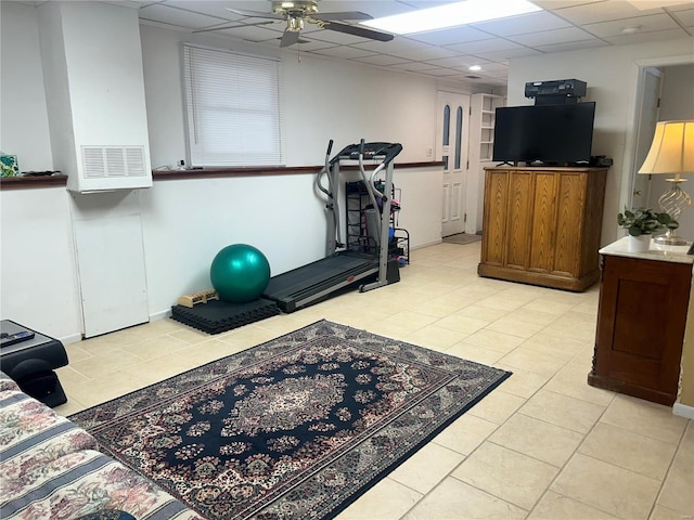 workout room featuring light tile patterned floors, a drop ceiling, and a ceiling fan