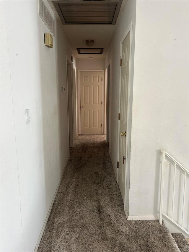 corridor featuring carpet flooring, visible vents, and baseboards