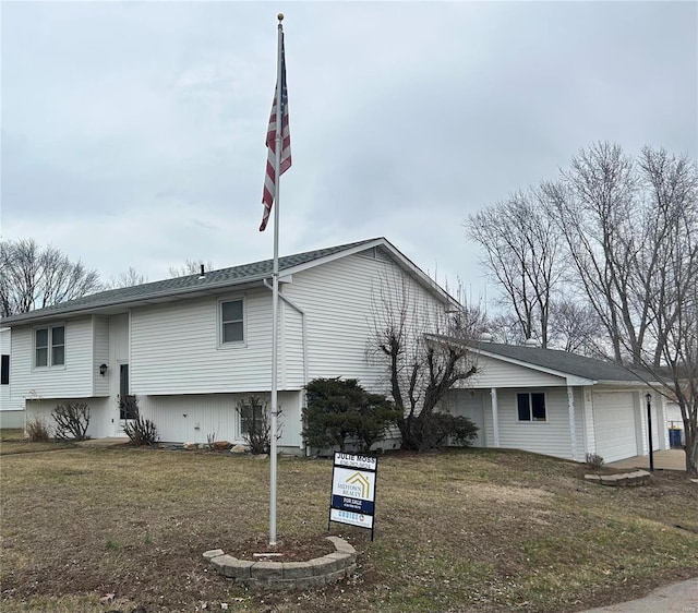 view of front of property with a front lawn and an attached garage