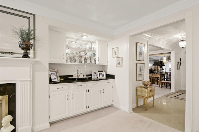 bar featuring crown molding, baseboards, and light tile patterned floors