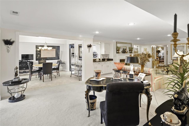 living room featuring a chandelier, visible vents, light colored carpet, and recessed lighting