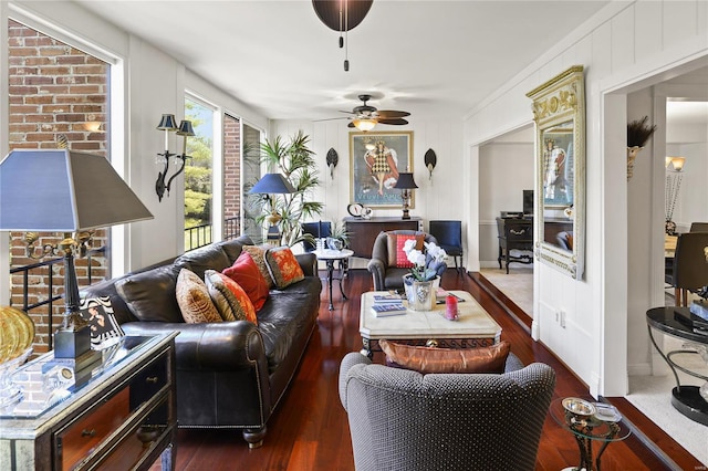 living area featuring a ceiling fan and dark wood-type flooring