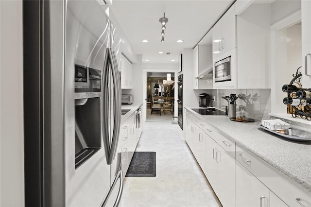 kitchen featuring decorative backsplash, light countertops, black appliances, and white cabinetry