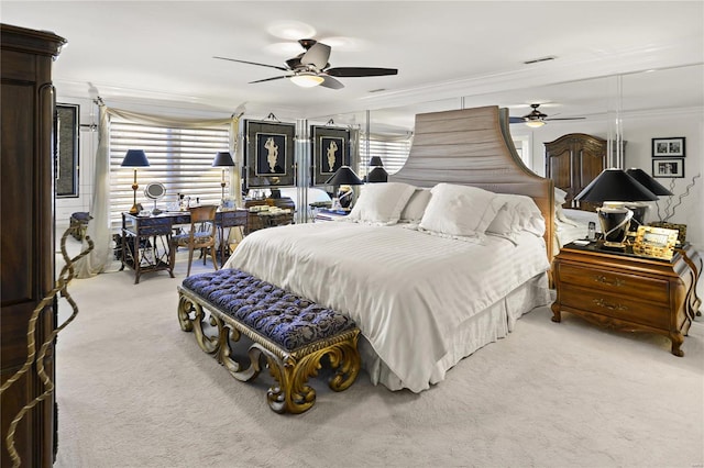 bedroom featuring ornamental molding, light carpet, ceiling fan, and visible vents