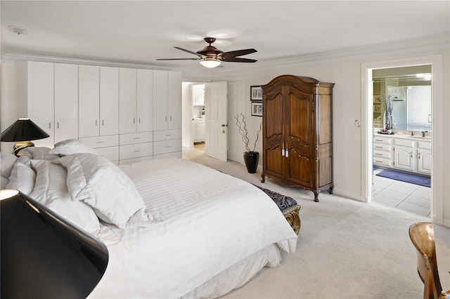 bedroom featuring connected bathroom, light colored carpet, crown molding, and ceiling fan