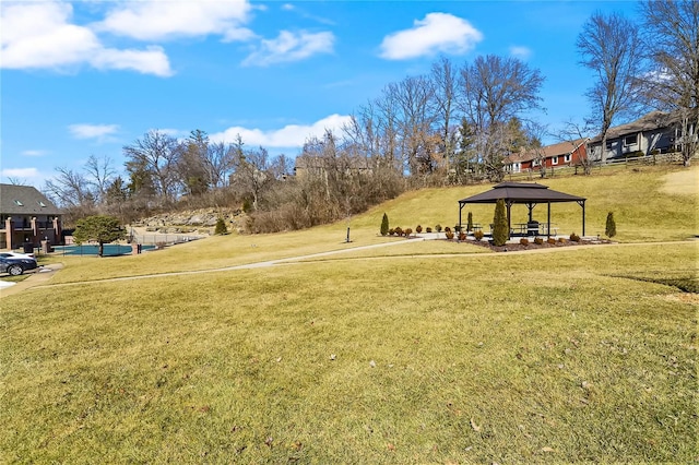 view of property's community featuring a gazebo and a lawn