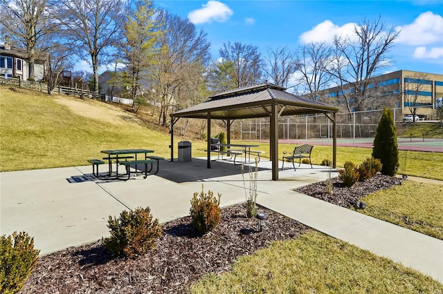 surrounding community with a yard, a tennis court, fence, and a gazebo