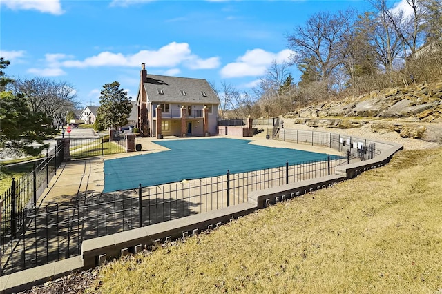 community pool featuring a patio and fence