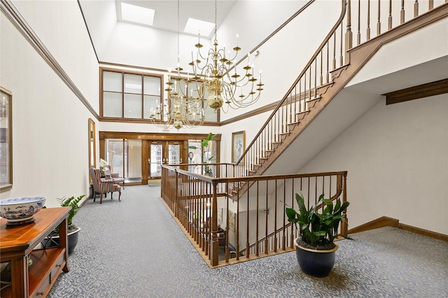 interior space with french doors, stairway, a high ceiling, a chandelier, and baseboards