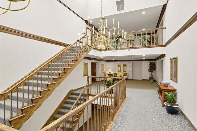 stairs with recessed lighting, a high ceiling, carpet flooring, visible vents, and baseboards