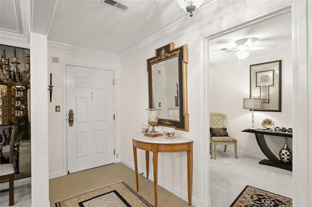 entrance foyer with baseboards, visible vents, ceiling fan, crown molding, and light tile patterned flooring