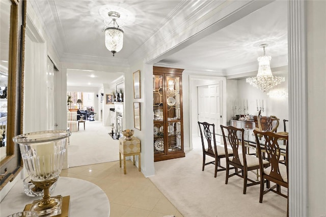 corridor featuring a chandelier, light carpet, crown molding, and light tile patterned floors