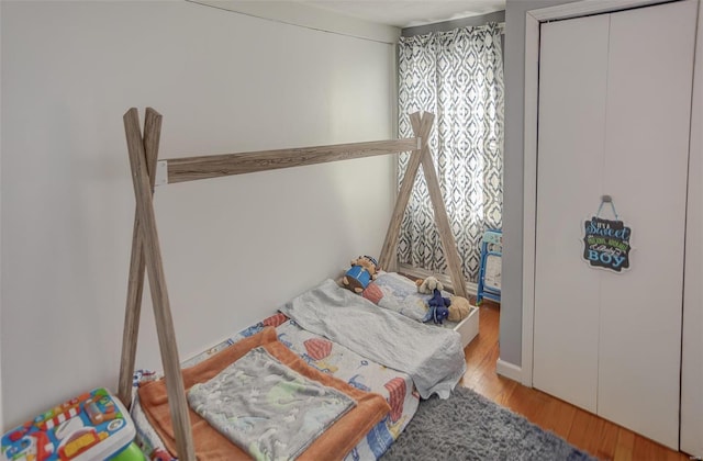 bedroom featuring light wood-type flooring and a closet