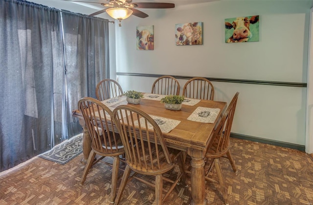 dining room featuring ceiling fan and baseboards