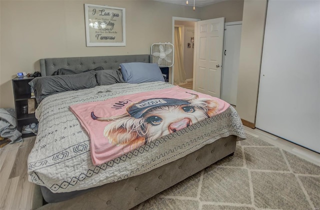 bedroom with light wood-type flooring and baseboards