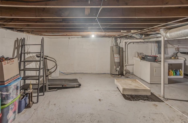 unfinished below grade area featuring gas water heater and washer and dryer