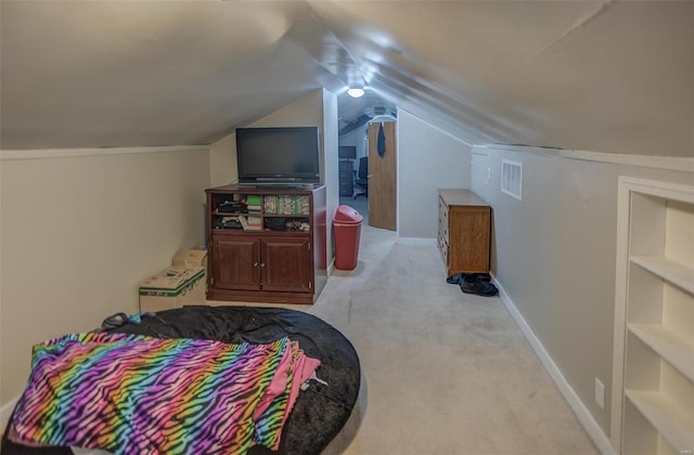 bedroom featuring light carpet, visible vents, baseboards, and vaulted ceiling