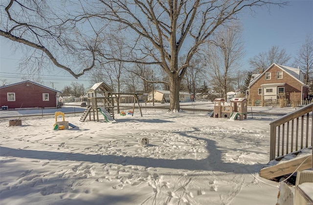 yard layered in snow with playground community