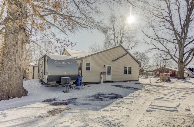 snow covered house with fence