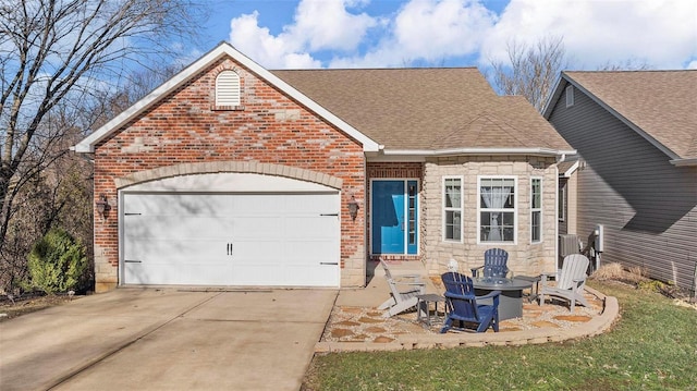 view of front of property with a garage, driveway, brick siding, and roof with shingles