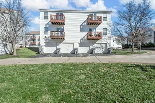 exterior space featuring a lawn and a balcony