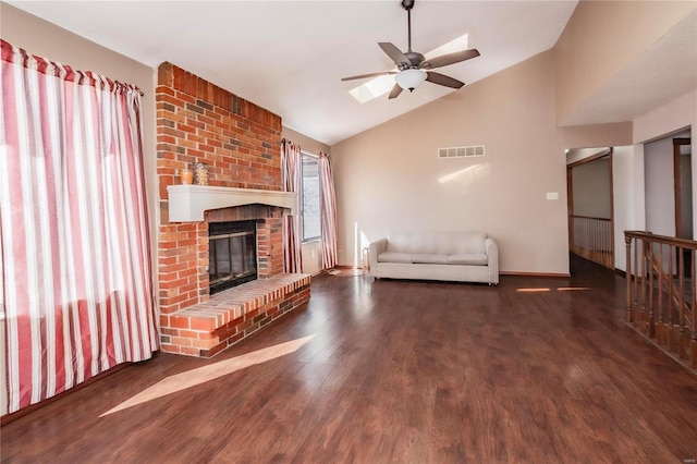 unfurnished living room featuring a fireplace, visible vents, ceiling fan, vaulted ceiling, and wood finished floors