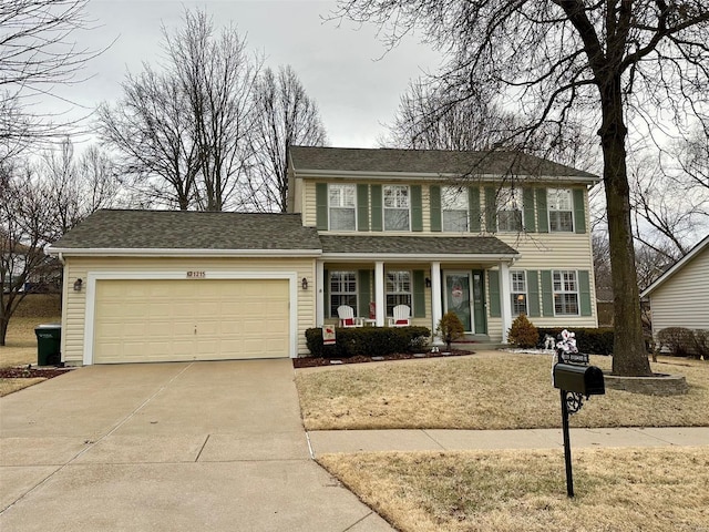 colonial-style house featuring a garage, concrete driveway, a porch, and a shingled roof