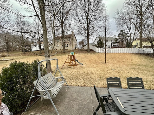 view of home's community with outdoor dining space, a patio area, a playground, and fence