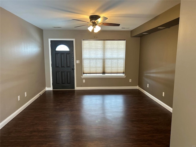 entrance foyer featuring ceiling fan, dark wood finished floors, and baseboards