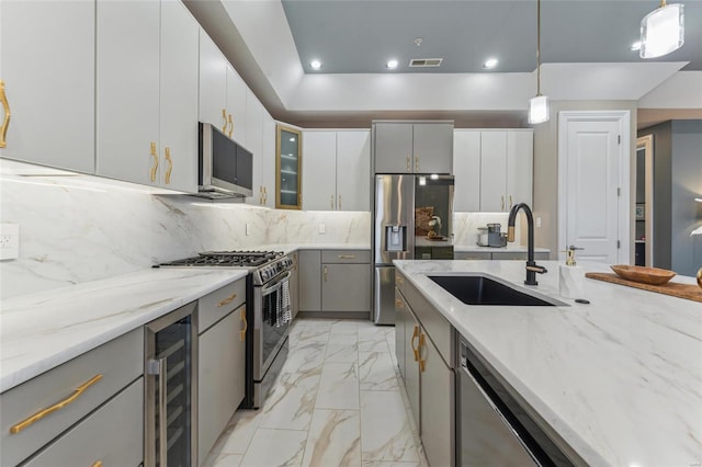 kitchen featuring wine cooler, gray cabinets, marble finish floor, stainless steel appliances, and a sink