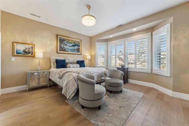 bedroom with recessed lighting, visible vents, baseboards, and light wood finished floors