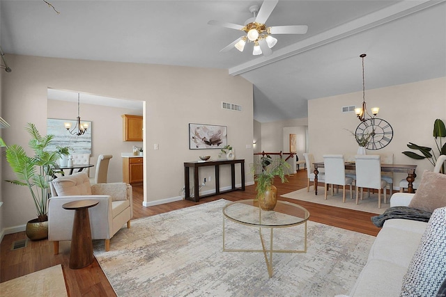 living area featuring lofted ceiling with beams, wood finished floors, and visible vents