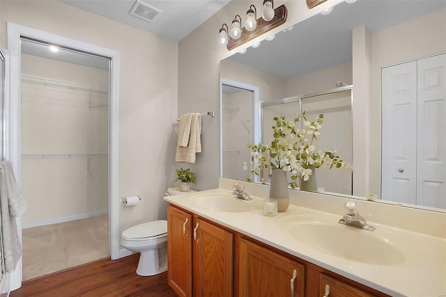 full bathroom with toilet, a closet, a sink, and visible vents