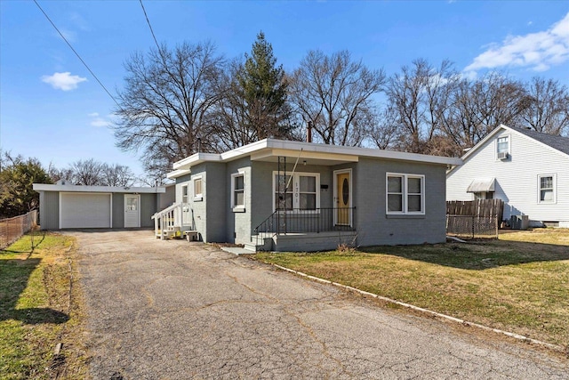 view of front facade with aphalt driveway, a porch, a front lawn, and fence