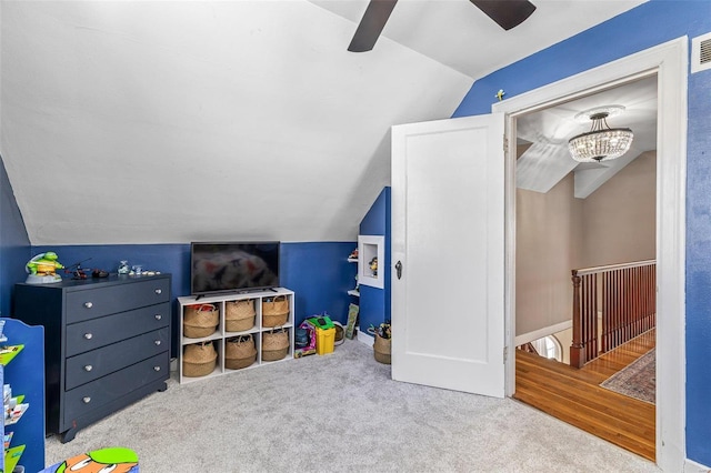 recreation room with lofted ceiling, a ceiling fan, visible vents, and light colored carpet