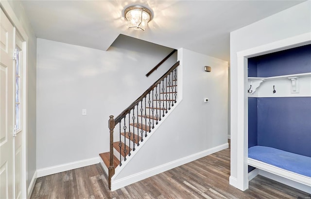 interior space with stairs, baseboards, and wood finished floors