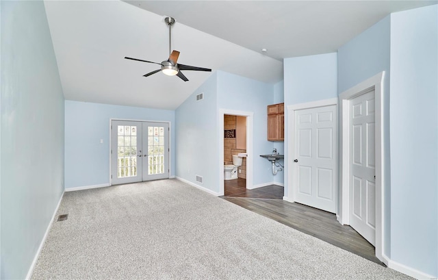 interior space featuring baseboards, visible vents, dark colored carpet, and french doors