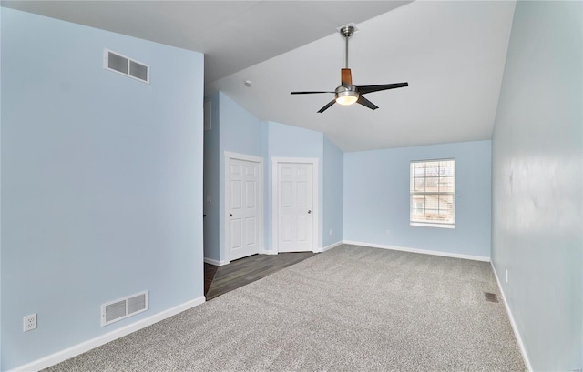 unfurnished room featuring ceiling fan, dark carpet, visible vents, and baseboards