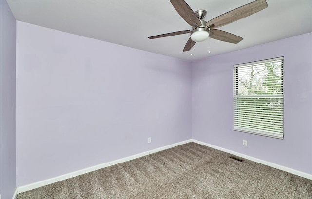 unfurnished room featuring a ceiling fan, baseboards, visible vents, and carpet flooring