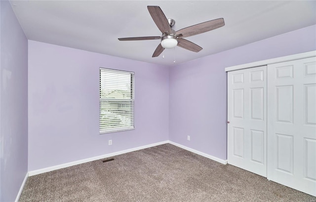 unfurnished bedroom with a closet, carpet flooring, a ceiling fan, and baseboards