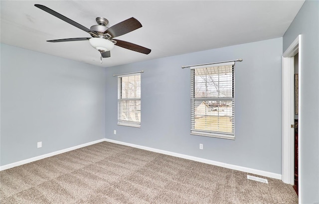 unfurnished room with a ceiling fan, carpet, visible vents, and baseboards