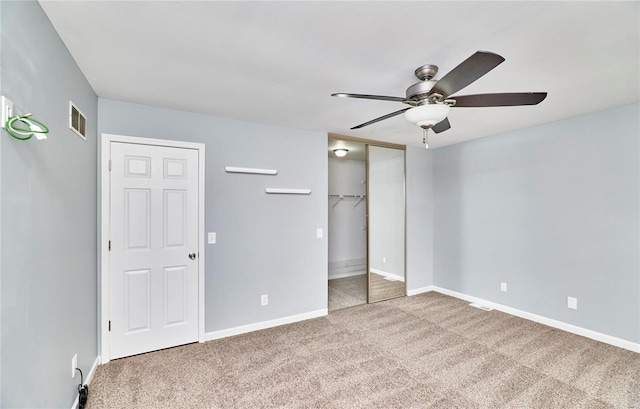 unfurnished bedroom featuring ceiling fan, carpet, visible vents, and baseboards