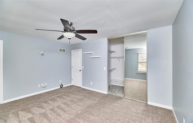 unfurnished bedroom featuring carpet floors, baseboards, visible vents, and a ceiling fan