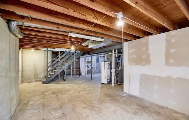 unfinished basement featuring stairs, gas water heater, and heating unit