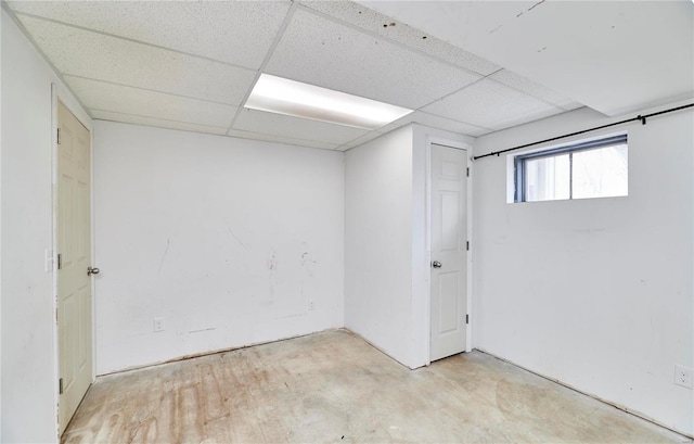 basement with a paneled ceiling